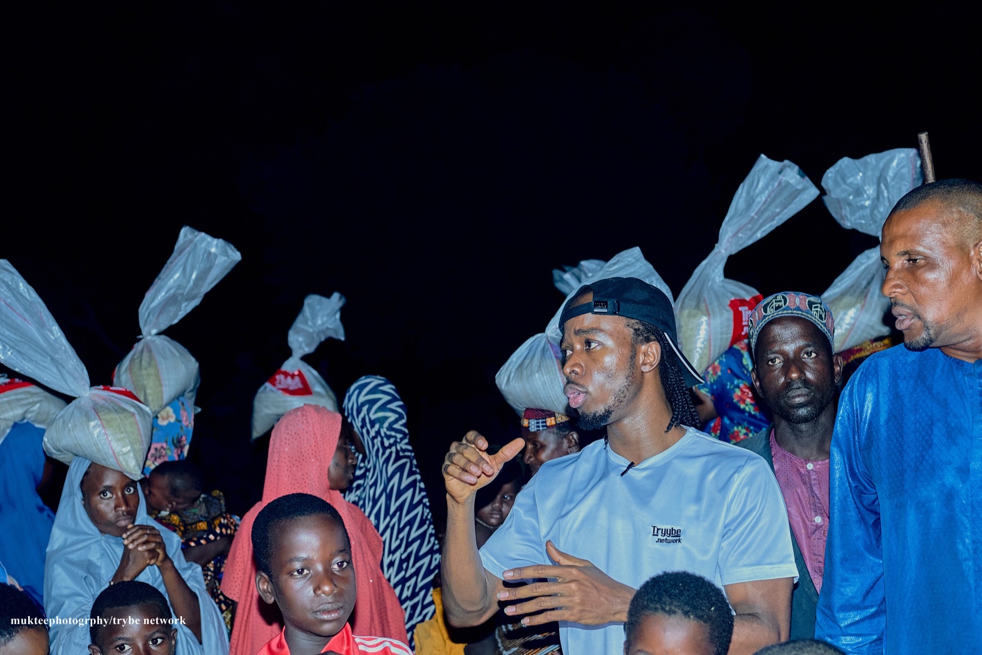 Joshua Brendan standing with beneficiaries of the Tryybe Christmas relief program
