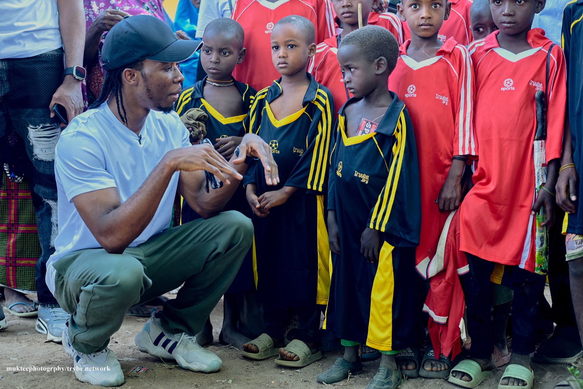 Joshua Brendan with children at the Tryybe relief program