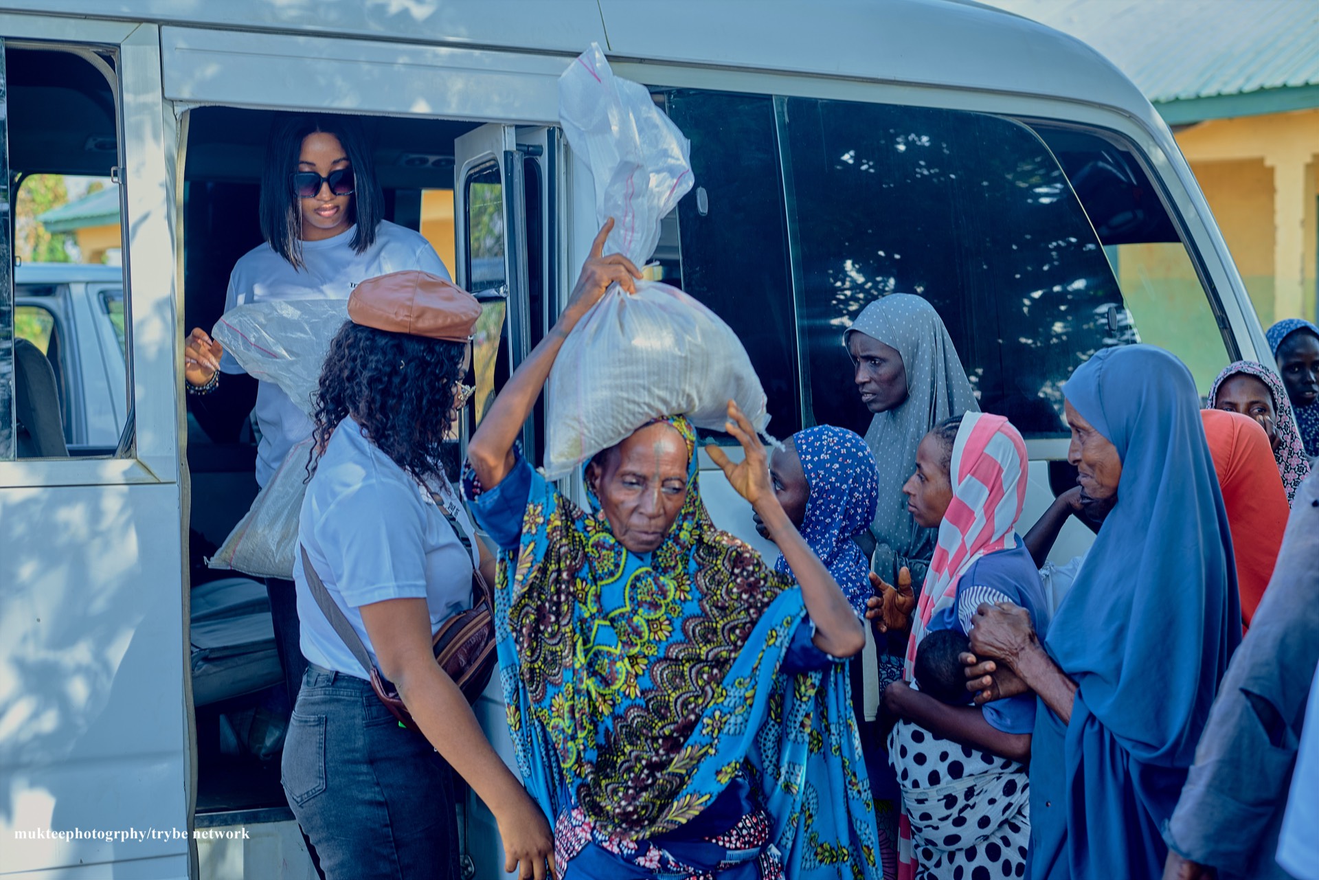 A woman carrying a Tryybe relief package on her head