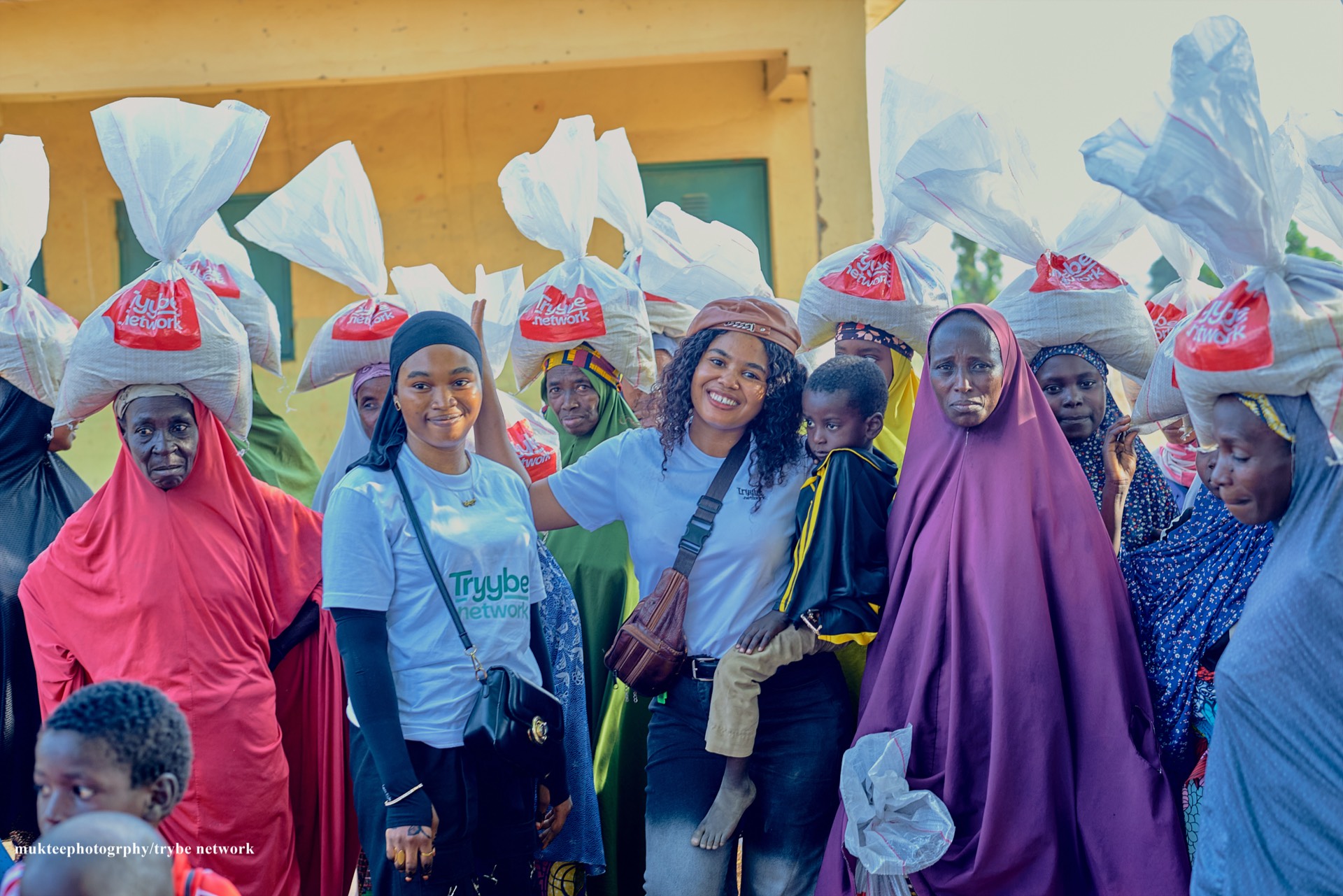 Tryybe members with smiling recipients of the relief program